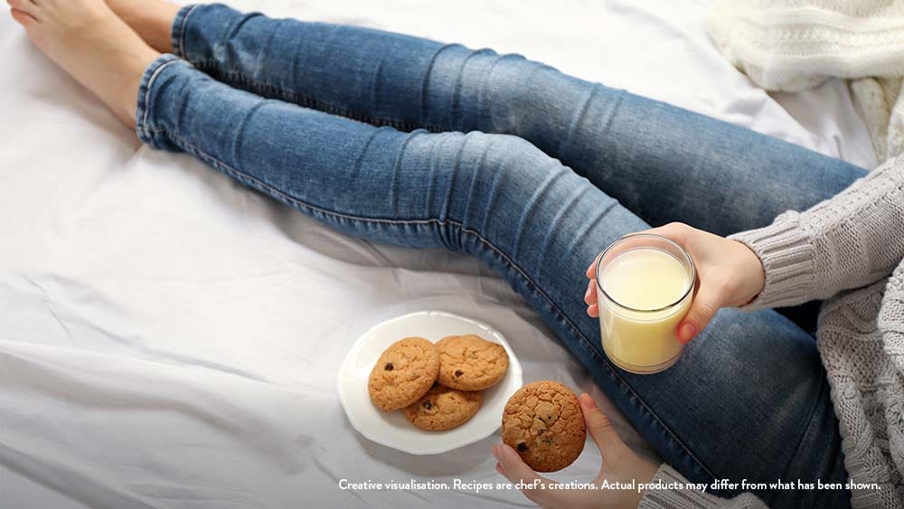 Girl eating cookies and drinking SOFIT drinks